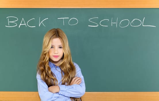 kid student girl on green school blackboard with written back to school text