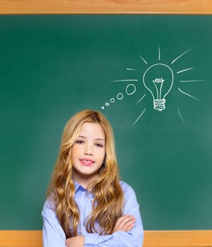 kid student girl on green school blackboard and drawn light bulb idea