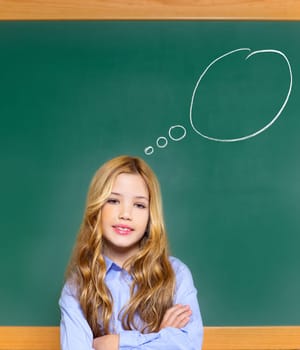 kid student girl on green school blackboard having a good idea