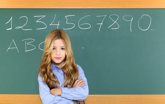 kid student girl on green school blackboard and chalk written letters and numbers