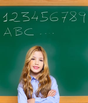 kid student girl on green school blackboard and chalk written letters and numbers