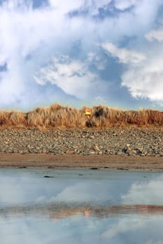 a lifebuoy on the beach sand dunes in beal county kerry ireland