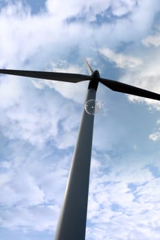 a wind turbine against a calm cloudy sky with a bubble floating