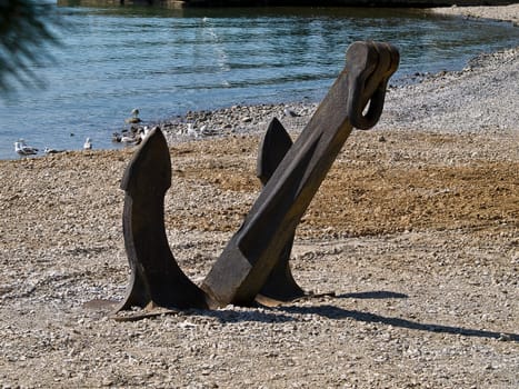 old anchor placed on the beach