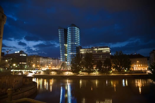 glas front of the Uniqa tower in vienna illuminated with different colors ans special effects by night, Vienna