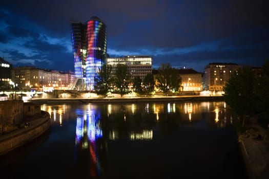 glas front of the Uniqa tower in vienna illuminated with different colors ans special effects by night, Vienna