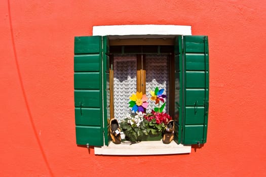 beautiful colored houses and windows  of the old fishermans  city Burano in the laguna of Venice