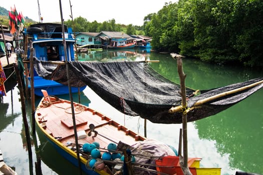 fish will be dried in a fisherboat in a small fishermans village in Koh Chang, Thailand