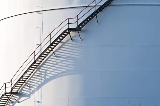 industrial stair at white tank in tank farm