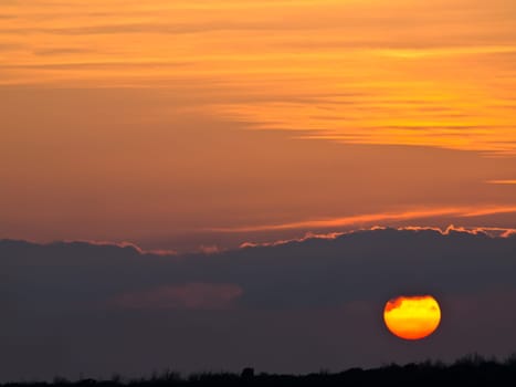 sunset with clouds on red sky