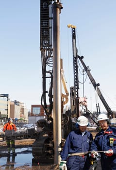 building workers and heavy machinery inside construction site
