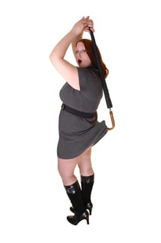 A pretty woman in a gray dress and black boots lifting with an umbrella her dress up in the back, over white background.