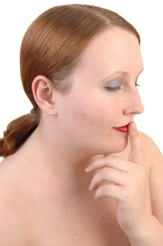 A profile closeup portrait of a young lovely woman with her eyes closed and one finger over her mouth, with brunette hair over white.