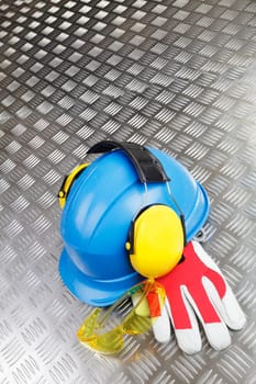 conceptual, hardhat, helmet and gloves against steel background
