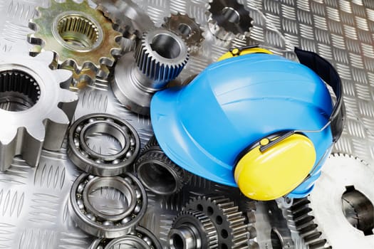 industrial hardhat, helmet with gear wheels and engineering parts, conceptual.