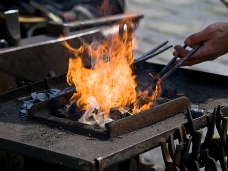 blacksmiths working with steel and fire