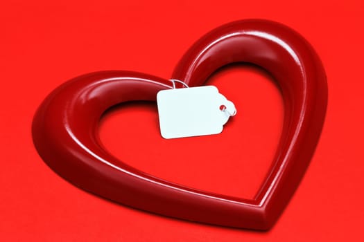 heart shape with tag over red background
