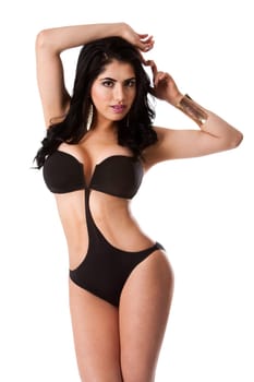 Beautiful happy young brunette woman in sexy black bikini standing and hands on head, isolated.
