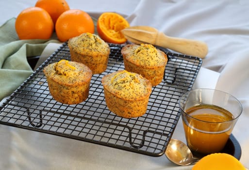 Fresh baked orange and poppyseed cakes straight out of the oven.