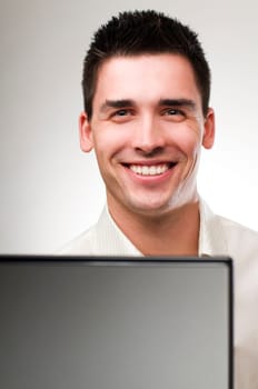 Young business man with laptop close up