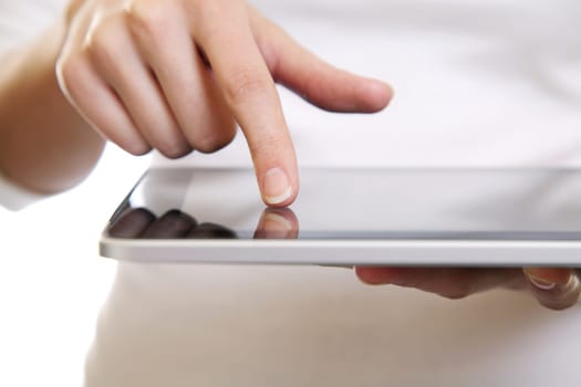 Hand of a woman using a digital tablet