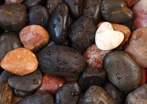 Background of White stone heart surrounded by other stones
