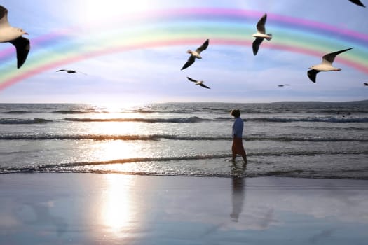 a lady walking in the warm sea reflecting with nature in deep meditation