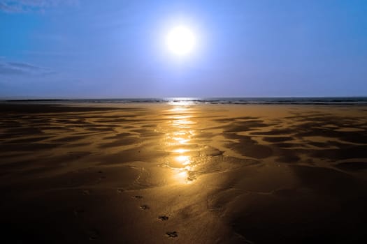 sunshine reflected on a golden beach of the west coast of ireland