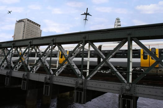 train and planes passing over a bridge in london city