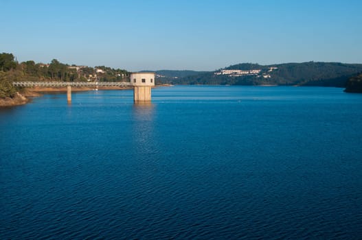 stunning view of river Zezere and Castelo de Bode Dam in Tomar, Portugal (gorgeous blue sky)