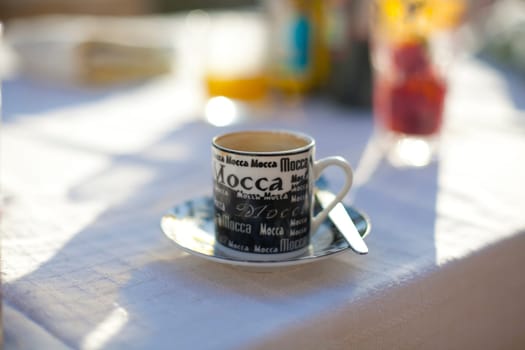 Close-up of a coffee cup on an outdoor table