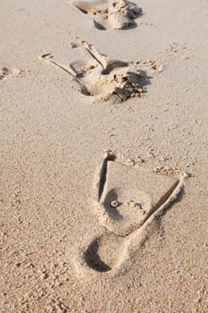 Close-up of footprints with fins on sand