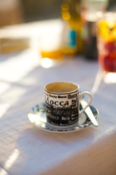 Close-up of a coffee cup on an outdoor table
