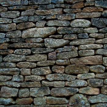 Old and weathered stone wall background, square photography