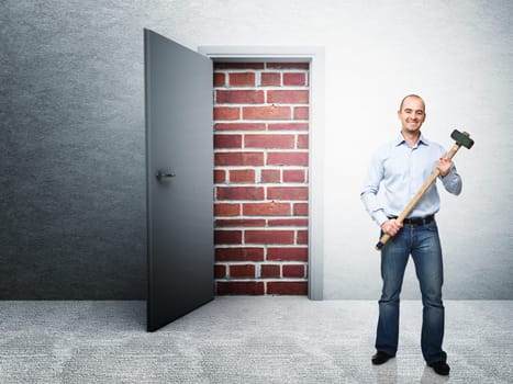 standing man with hammer and closed door