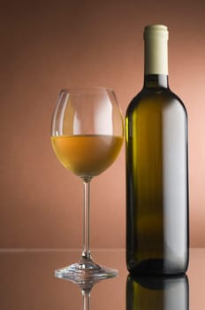 Bottle with white wine and glass close up