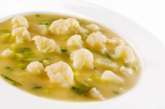 Fresh cauliflower soup with leek close up