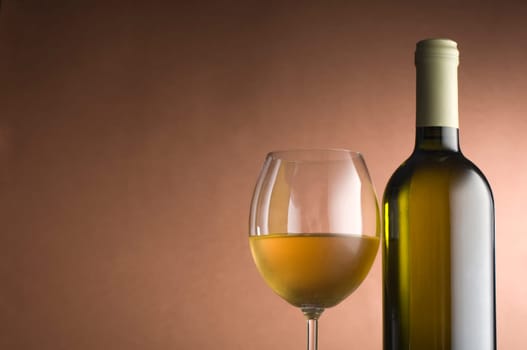 Bottle with white wine and glass close up