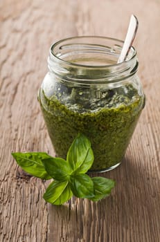 Fresh basil pesto in a jar close up