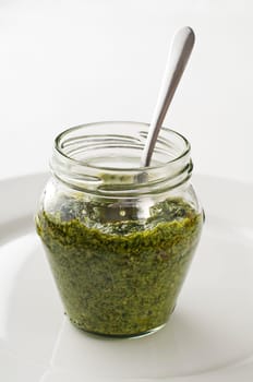 Fresh italian basil pesto in a jar close up
