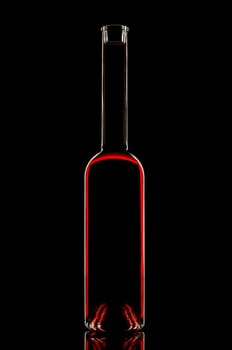 Bottle with red wine on black background