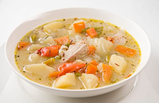 Fresh vegetable soup with chicken close up