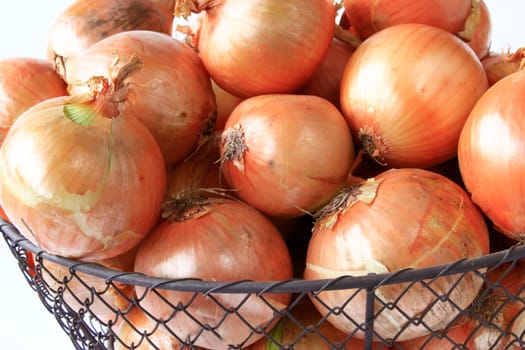 large onions in a decorative wire basket