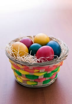 Colorful easter eggs in a basket close up