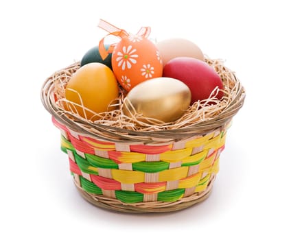 Colorful easter eggs in a basket isolated on white