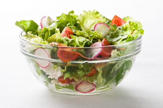 Fresh green salad with tomato close up shoot