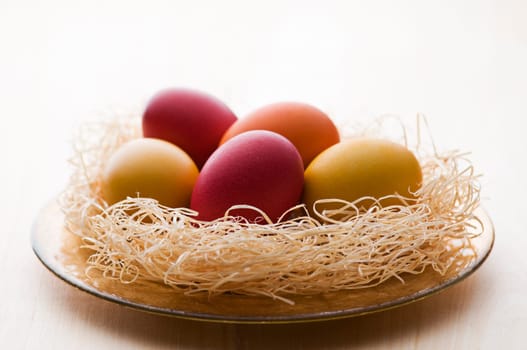 Colorful easter eggs on a plate close up
