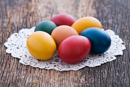 Colorful easter eggs on wooden background close up
