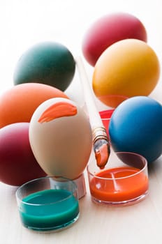 Colorful easter eggs with brush and paint close up