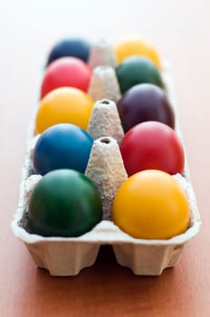 Colorful easter eggs in a box close up